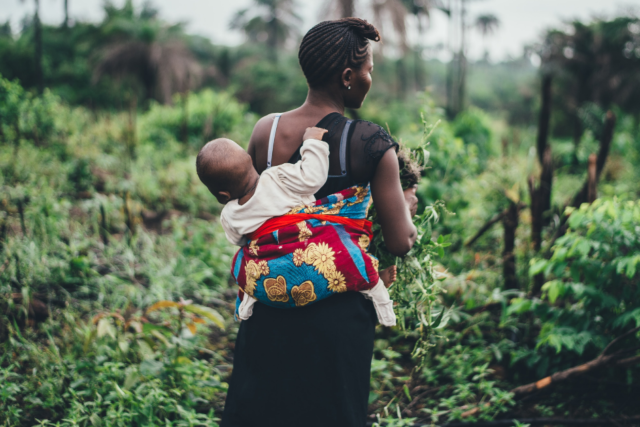 Mother and her child in the tropical forest of Sierra Leone.